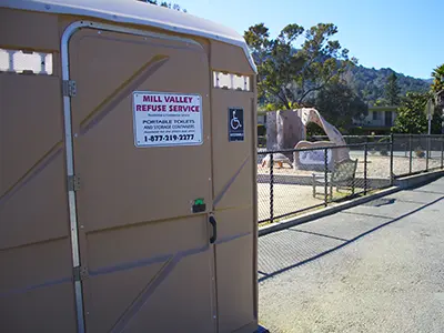 Portable toilet rental in front of Marin park