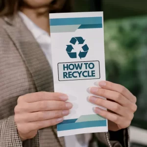 Woman holds a How to Recycle Brochure